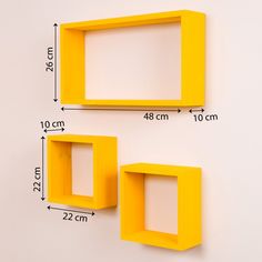 two yellow square shelves on the wall