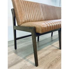 a brown bench sitting on top of a hard wood floor