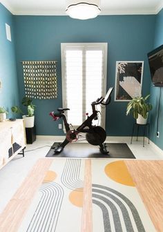 a room with a bike and rugs on the floor