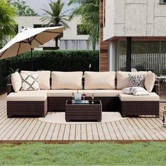 an outdoor living area with patio furniture and umbrella