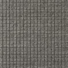 a gray tile wall with small squares on it