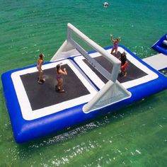 people are playing on an inflatable water tram