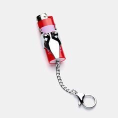 a red and white lighter shaped like a penguin keychain with a chain attached to it