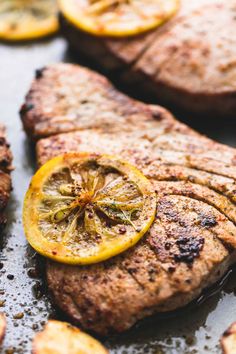 grilled meat with lemon slices and spices on the side, ready to be eaten