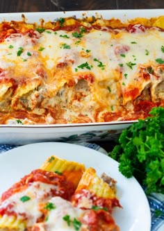 an enchilada casserole with meat, cheese and parsley on the side