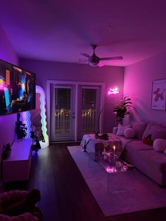 a living room filled with furniture and purple lighting