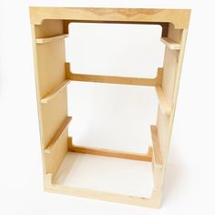 a wooden shelf with three shelves on one side and two open spaces on the other