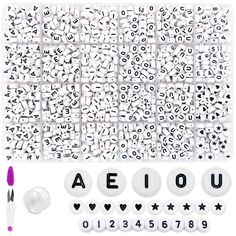 an assortment of letters and numbers on a white surface with marker pens, glues and markers