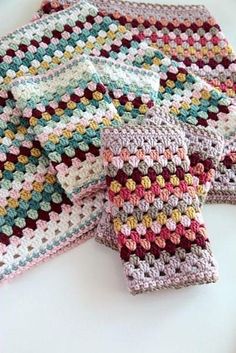 three crocheted dishcloths on a white surface