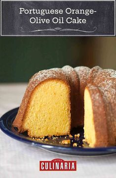 a bundt cake on a blue plate with powdered sugar