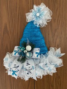 a blue and white christmas tree decoration hanging on a door