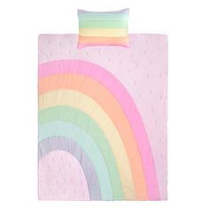 a pink bed with a rainbow print on the cover and pillowcase, along with two pillows