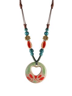 a necklace with a heart shaped pendant and beads on the front, hanging from a leather cord