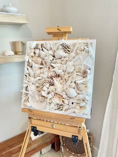 an easel with seashells painted on it