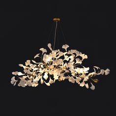 a large chandelier with white flowers hanging from it's center and two lights on each side