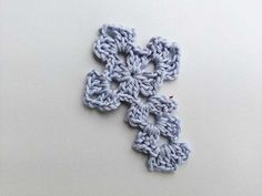 a crocheted cross on a white surface