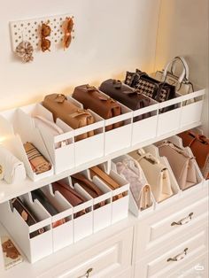 an organized closet with white drawers and lots of purses