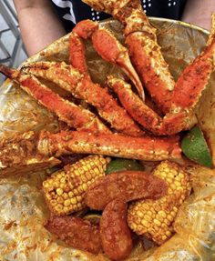 crab legs and corn on the cob are served in foil