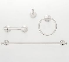 an assortment of bathroom accessories including toilet paper and towel bar, on a white background