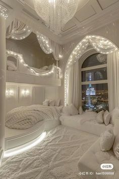 a bedroom decorated in white with lots of lights on the ceiling and windows above it