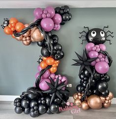 balloons are arranged in the shape of an animal, spider and pumpkin balloon art display