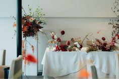 the table is set up with flowers and candles for an elegant wedding reception or special event