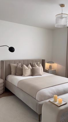 a bedroom with a large bed and white walls