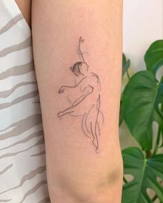 a woman's arm with a tattoo on it that has a line drawing of a ballerina