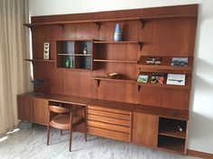 a wooden desk and shelves in a room