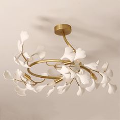 a chandelier with white flowers hanging from it