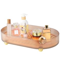 a wooden tray with cosmetics and perfume bottles sitting on it's sides, along with other beauty products