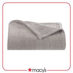 an image of a blanket that is folded up on top of a bed with the words macy's written below it