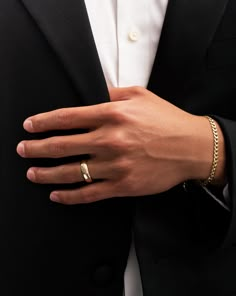 a man in a tuxedo wearing a gold ring