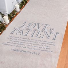 a large white rug with the words love is patient written on it and candles around it