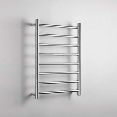 an electric towel warmer mounted on the wall in a room with white walls and flooring