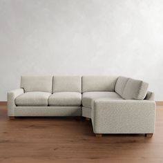 a white couch sitting on top of a wooden floor