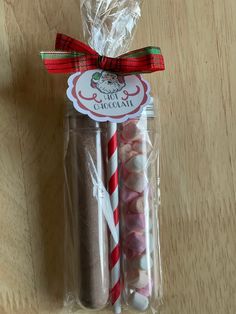 three candy canes wrapped in cellophane and tied with ribbon