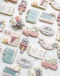 cookies decorated with baby's names and flowers on a marble table top for a celebration