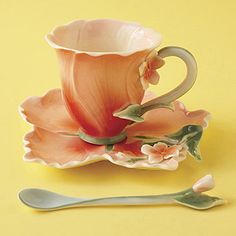 a tea cup and saucer sitting next to each other