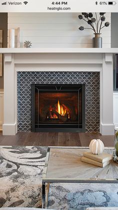 a living room filled with furniture and a fire place in front of a flat screen tv