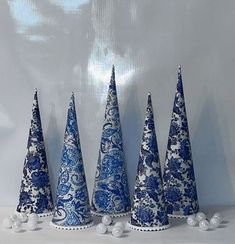 five blue and white christmas trees are lined up