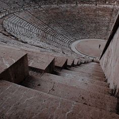 an empty stone arena with steps leading up to it