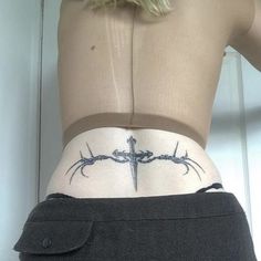 a woman with a cross tattoo on her stomach