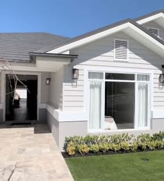 a white house with a black door and windows