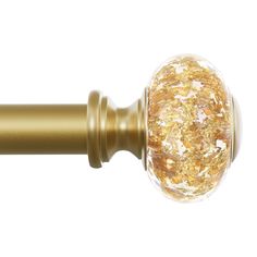 a close up of a gold colored curtain rod with a glass ball on it's end