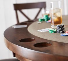 a table with poker chips on it and two shots in the glass next to it