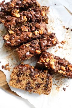 chocolate chip cookie bars cut into squares and stacked on top of each other with chopped walnuts