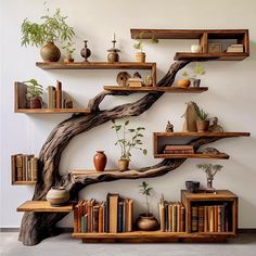 the bookshelves and shelves are made from tree branches, with plants on them