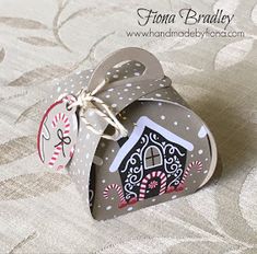 an ornament in the shape of a heart with a house on it