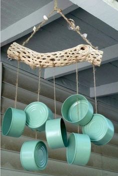 some green cups hanging from a wooden beam